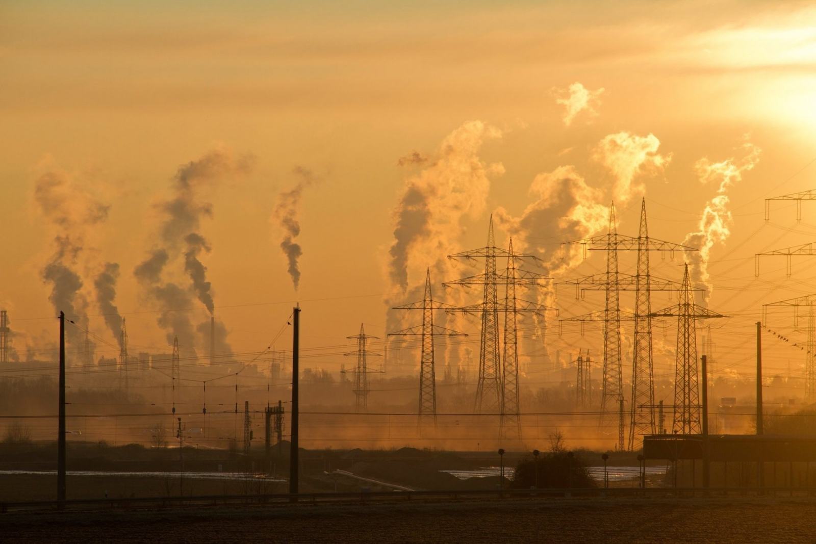 Power transmission lines and industry at sunset
